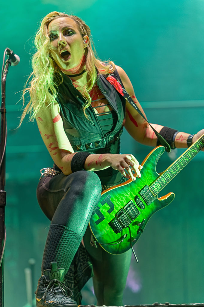 An image of female guitarist, Nita Strauss, in concert