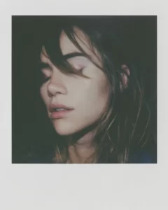 A Polaroid image of singer, model and actress, Suki Waterhouse, with her eyes closed