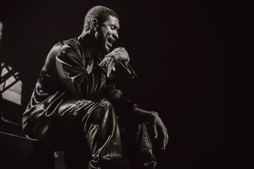 A close-up photo of Usher performing while live