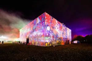 An image of a flourescent cube shaped building celebrating music