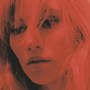 A close-up photo of singer, actress, and model, Suki Waterhouse promoting her new single, 'To Love'