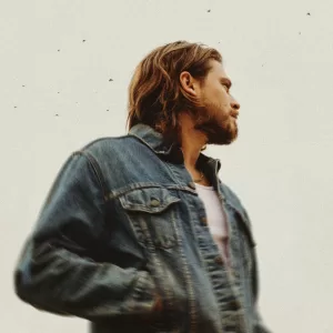 A side shot of Cory Asbury, who is looking away from the camera