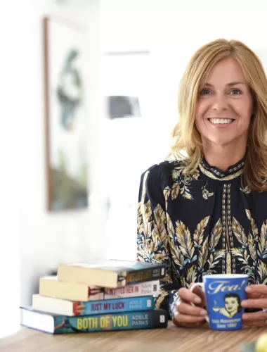 An image of author, Adele Parks, holding a coffee mug