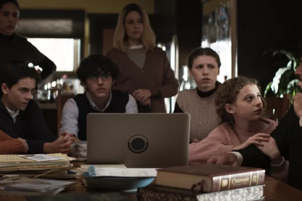 A still image from the new film, 'Guns and Moses,' featuring family members sitting around a computer
