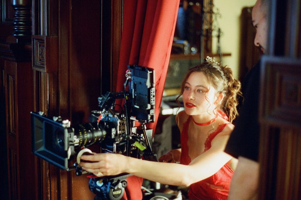 A behind-the-scenes image of Gabrielle filming on set