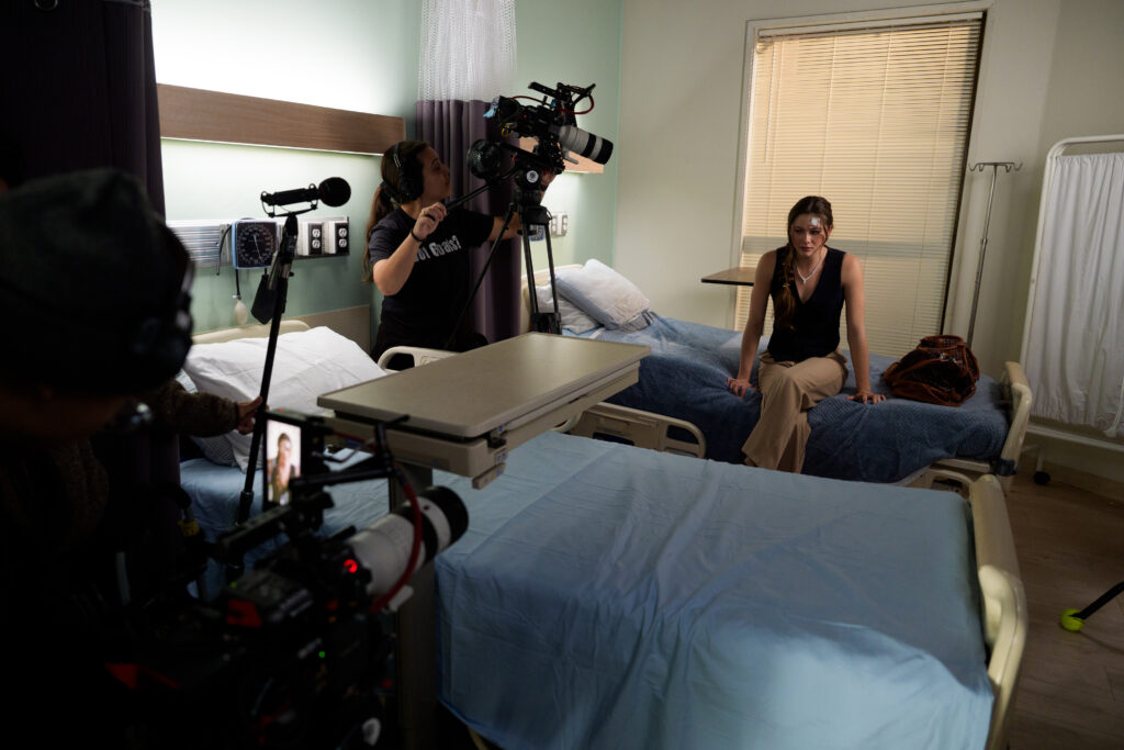 An image still of Gabrielle filming behind-the-scenes