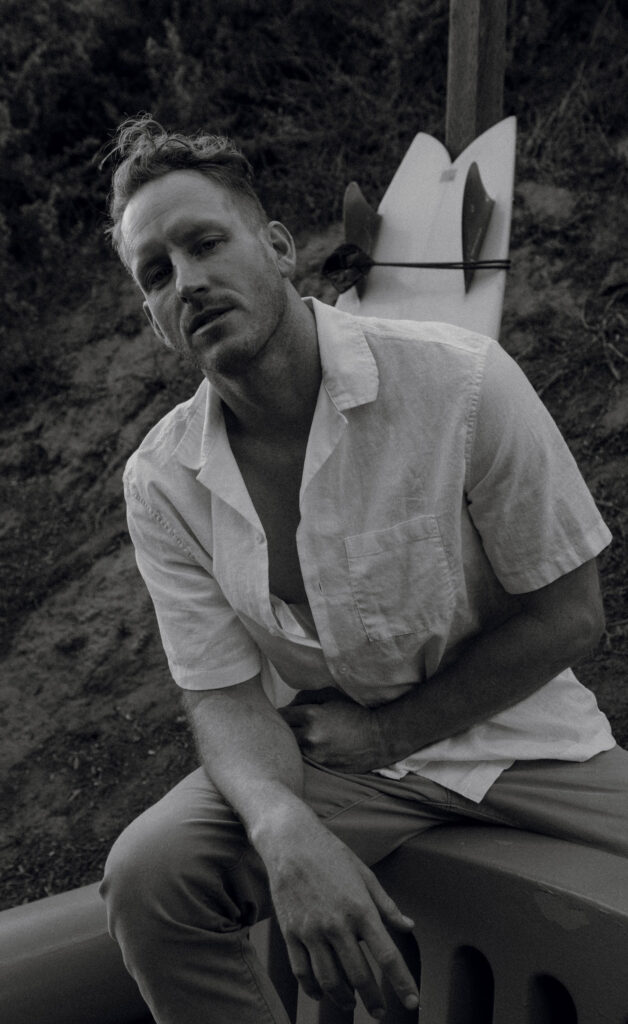 A black and white image of vertical actor, Aaron Oberst